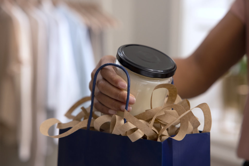 Flourish Spiral Fill in a paper bag with a glass jar being placed into it